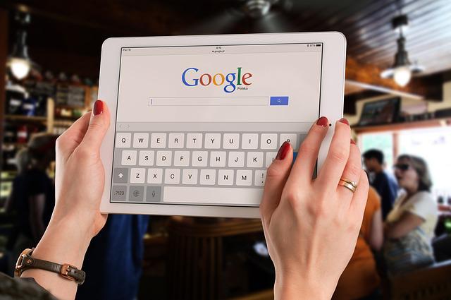 Google na tablecie w dłoniach kobiety